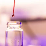 Detail photo of a solution droplet on the end of a glass dropper before going into a glass vial in the Polymer Characterization Laboratory for a research photo created on January 19, 2023. Photo by Steven Bridges/University of Tennessee.