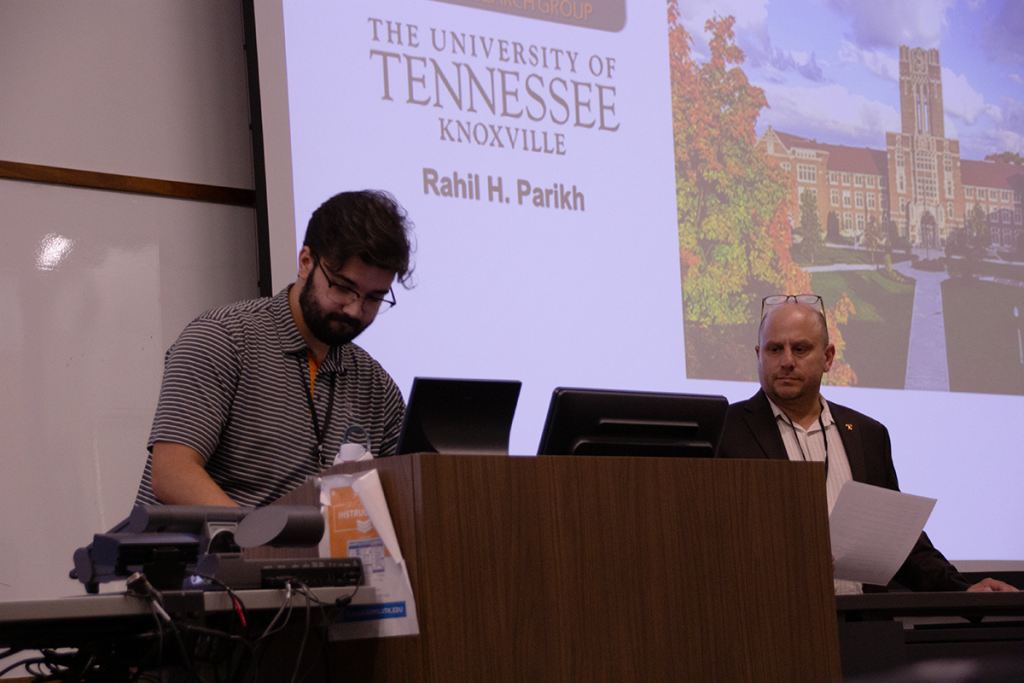 Rahil Parikh sets up for his oral presentation as Dr. Michael Best waits to introduce him.