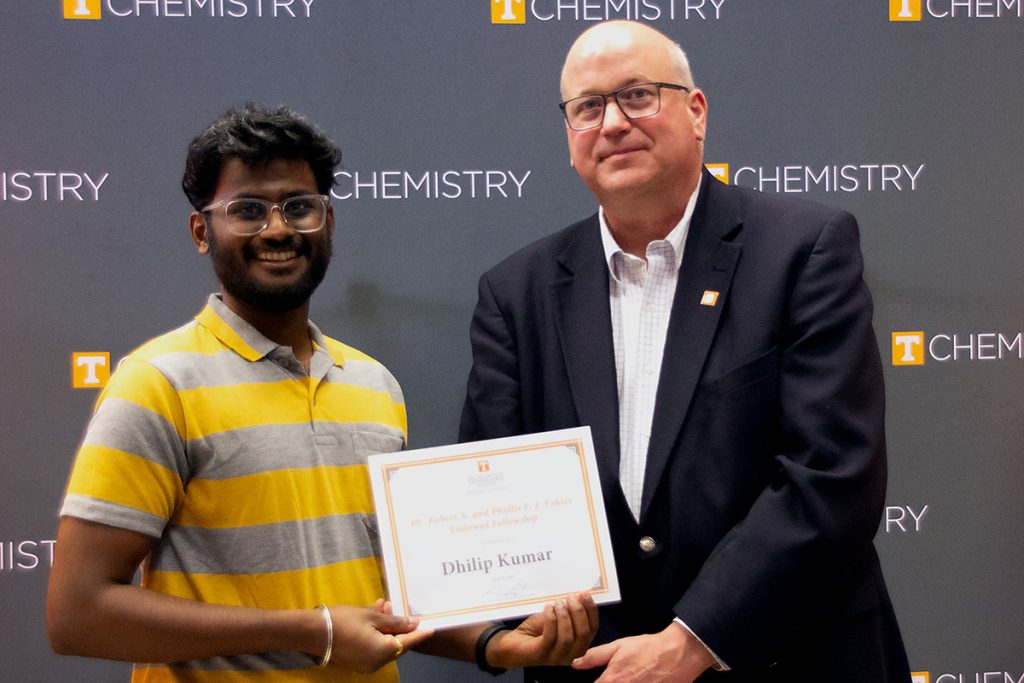 Dhilip Kumar stands with Dr. Shaughnessy holding the certificate for his award.
