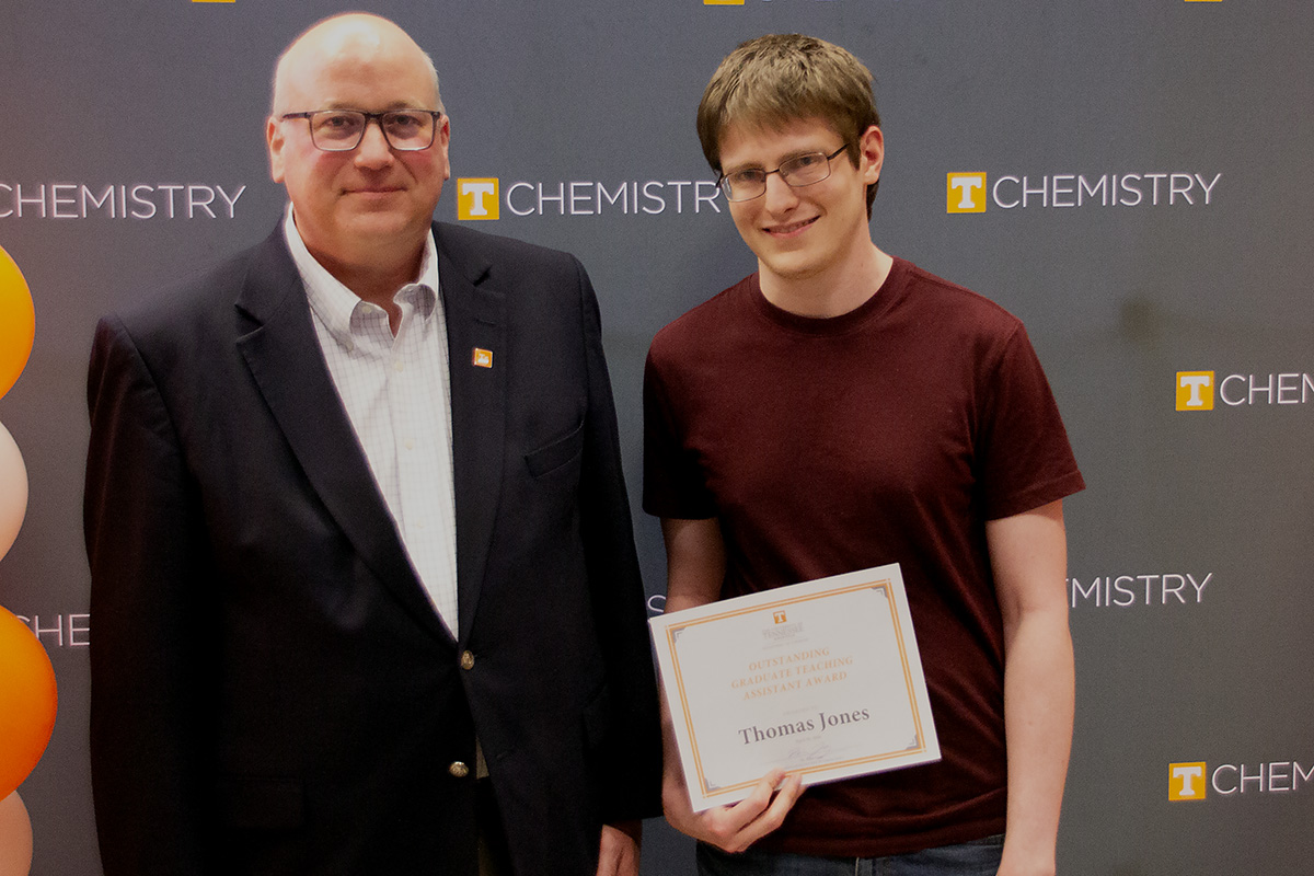 Thomas Jones stands with Dr. Shaughnessy holding the certificate for his award.