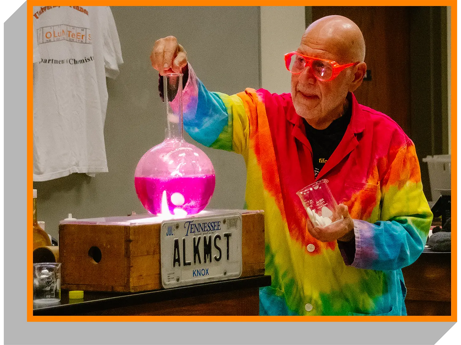 Retired Lab Director Al Hazari conducts an experiment using a large bulb test tube.